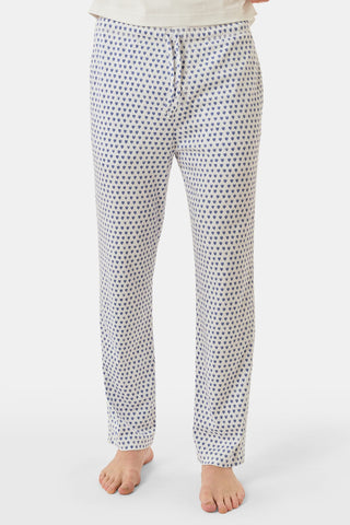 The Roller Rabbit Mens Hearts Simon Pant features white pajama pants with a blue dotted pattern, a drawstring waistband, and wide legs, displayed on a plain white background.