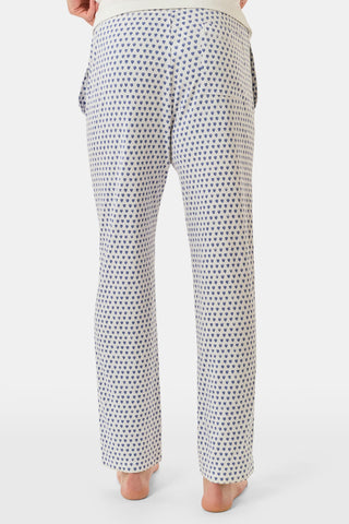 The Roller Rabbit Mens Hearts Simon Pant features white pajama pants with a blue dotted pattern, a drawstring waistband, and wide legs, displayed on a plain white background.