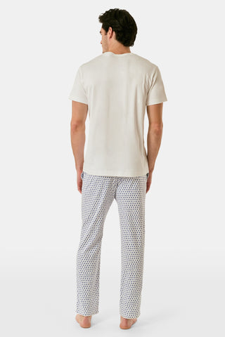 The Roller Rabbit Mens Hearts Simon Pant features white pajama pants with a blue dotted pattern, a drawstring waistband, and wide legs, displayed on a plain white background.