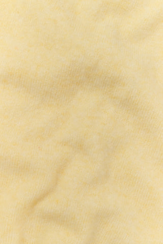 A person wearing the Roller Rabbit Gaia Pant paired with a light yellow knit sweater and beige slippers stands against a plain white background.