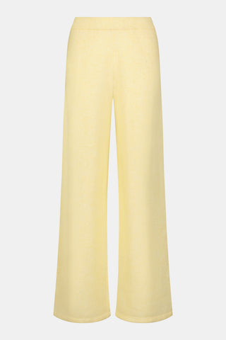 A person wearing the Roller Rabbit Gaia Pant paired with a light yellow knit sweater and beige slippers stands against a plain white background.