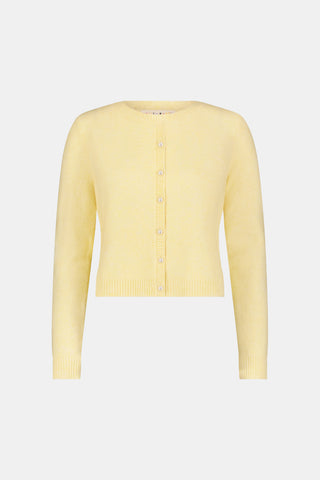 A woman wearing the Roller Rabbit Moxie Cardigan in butter yellow with matching pants, standing against a plain white background.