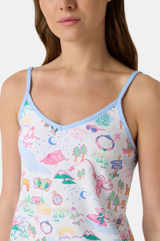 A woman stands barefoot in the Roller Rabbit Camp RR Mischa Set, a whimsical animal and floral print two-piece loungewear with a sleeveless V-neck tank with blue straps and matching drawstring waist shorts.