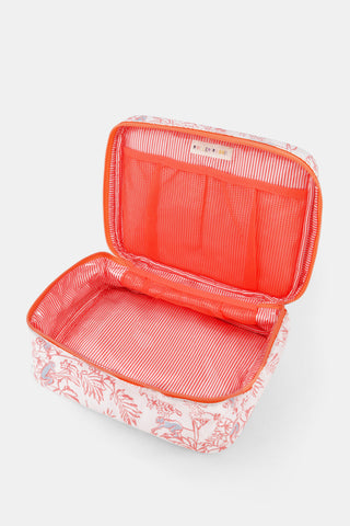 The Charlie Carry All Case by Roller Rabbit is a rectangular toiletry case crafted from water-resistant cotton canvas. It features a handle and zipper and showcases a vibrant red and blue nature and monkey print on a white background, making this stylish coral case both practical and eye-catching.
