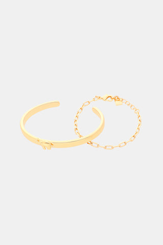 The Hathi Citra Bracelet Stack features a gold-tone open cuff bracelet with an elephant charm and a matching gold-tone chain bracelet, both crafted from plated brass.