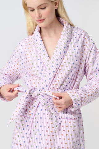 A woman stands barefoot in the Roller Rabbit Disco Hearts Cosmo Robe, featuring a subtle geometric pattern and a matching waist tie, facing forward against a plain white background.