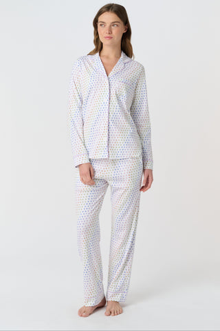 The Infant Disco Hearts Zipper Footie features white Pima cotton fabric with small, colorful, hand-drawn rainbow hearts evenly spaced across it. The soft material has a slightly wrinkled appearance.