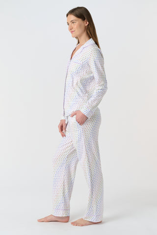The Infant Disco Hearts Zipper Footie features white Pima cotton fabric with small, colorful, hand-drawn rainbow hearts evenly spaced across it. The soft material has a slightly wrinkled appearance.