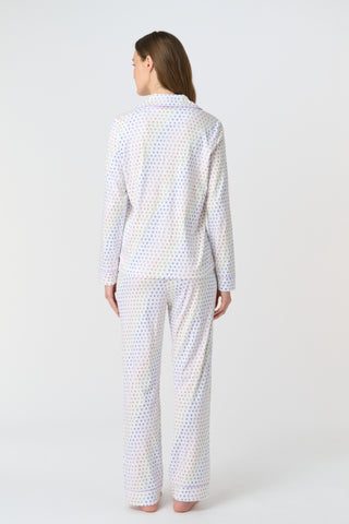 The Infant Disco Hearts Zipper Footie features white Pima cotton fabric with small, colorful, hand-drawn rainbow hearts evenly spaced across it. The soft material has a slightly wrinkled appearance.
