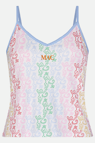 A woman stands barefoot wearing the Roller Rabbit Disco Monkey Lily Set, a matching Pima cotton pajama set featuring a pastel lace-like pattern, sleeveless camisole top, and drawstring pants with pockets.
