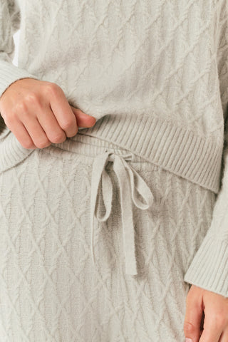 A person wearing the Roller Rabbit Cable Knots Olivia Pant in light gray, featuring a drawstring waist, paired with a matching top and white sneakers. The photo is cropped from shoulders down against a white background.
