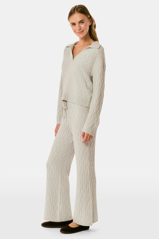 A person wearing the Roller Rabbit Cable Knots Olivia Pant in light gray, featuring a drawstring waist, paired with a matching top and white sneakers. The photo is cropped from shoulders down against a white background.