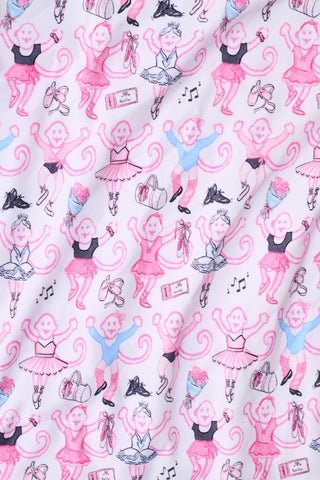 The Monkey Pirouette Polo Pajamas by Roller Rabbit feature a pink short-sleeve button-up top and matching shorts, adorned with a colorful and playful monkey, animal, and floral pattern on a white background.