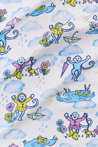 The Kids April Showers Pajamas feature a whimsical pattern with cartoon monkeys in raincoats, umbrellas, ducks, and more on white—perfect for colorful, playful spring or kids pajamas.