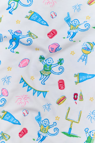 The Mens Game Day Troy Pajamas set by Roller Rabbit features a light blue short-sleeve t-shirt paired with white pajama pants decorated with colorful, playful cartoon animal and toy prints. The set is displayed on a plain white background.
