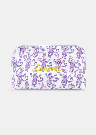 Introducing the STREET SMART Get Ready With Me Makeup Bag, featuring a whimsical white design adorned with playful purple monkeys holding bananas, lipstick, and shoes, surrounded by scattered lips and compact mirrors on a clean background.