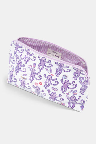 Introducing the STREET SMART Get Ready With Me Makeup Bag, featuring a whimsical white design adorned with playful purple monkeys holding bananas, lipstick, and shoes, surrounded by scattered lips and compact mirrors on a clean background.
