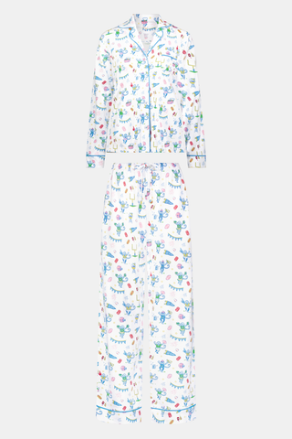 Roller Rabbit’s Game Day Long Sleeve Polo Pajamas feature a white button-up shirt and matching pants adorned with colorful, playful animal prints, festive bunting, and other cheerful designs.