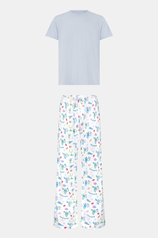 The Mens Game Day Troy Pajamas set by Roller Rabbit features a light blue short-sleeve t-shirt paired with white pajama pants decorated with colorful, playful cartoon animal and toy prints. The set is displayed on a plain white background.
