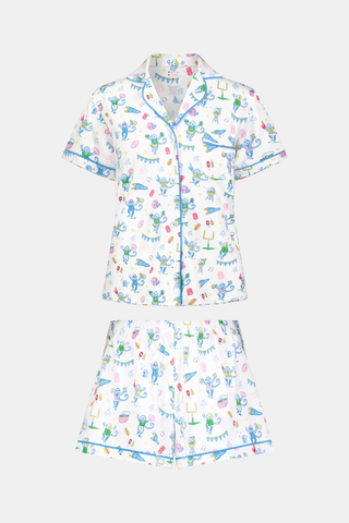The Game Day Polo Pajamas by Roller Rabbit feature a short-sleeve button-up top and shorts, adorned with a lively pattern of colorful cartoon animals and party items on a white background.