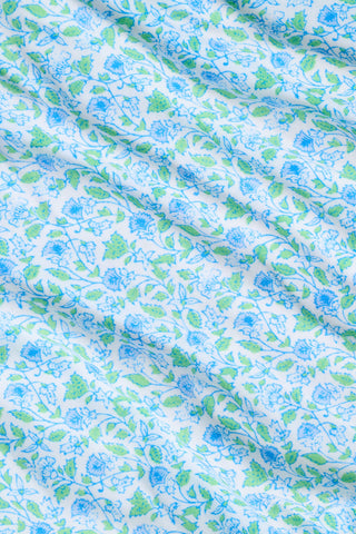 The Roller Rabbit Garden Gate Floral Daniela Slip Dress features a sleeveless, knee-length silhouette with thin straps, a blue and green floral Garden Gate print, and blue lace trim at the hem, shown against a plain white background.