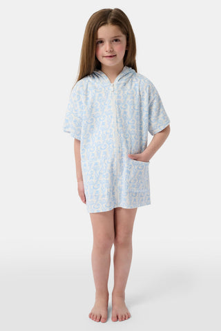 A young child smiles at the camera while wearing the Roller Rabbit Kids Monkey Jesse Cover Up, a light blue and white terry zip-up onesie with a playful animal pattern, against a plain background.