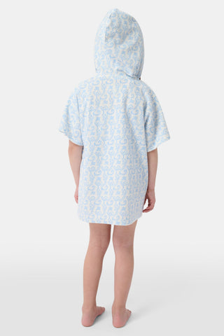 A young child smiles at the camera while wearing the Roller Rabbit Kids Monkey Jesse Cover Up, a light blue and white terry zip-up onesie with a playful animal pattern, against a plain background.
