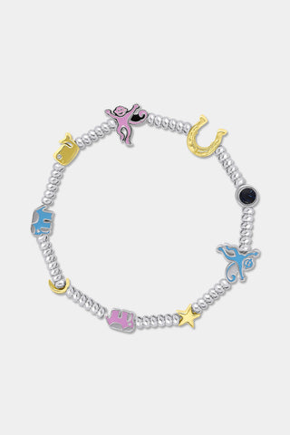The Icon Party Beaded Bracelet by Roller Rabbit features a beaded silver chain adorned with colorful charms—including a pink monkey, blue elephant, yellow horseshoe, star, moon, and a blue eye—set against a white background.