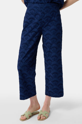 Navy patterned pants worn by a person on a white background