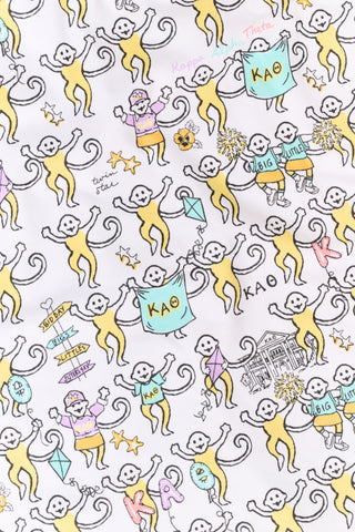 The Roller Rabbit Kappa Alpha Theta Monkey Pajamas set features a white, long-sleeved buttoned top and matching pants, both adorned with a vibrant all-over cartoon print of playful animal characters, including cheerful monkeys.