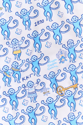 The Roller Rabbit Kappa Kappa Gamma Monkey Pajamas are a two-piece set with long sleeves and pants, showcasing an all-over blue and yellow monkey cartoon print on a white background, displayed on a flat white backdrop.