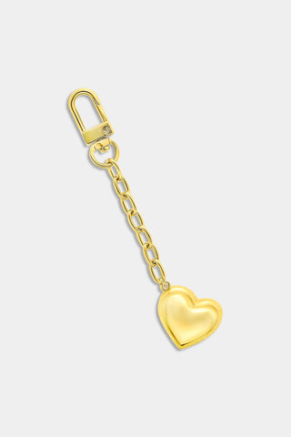 Roller Rabbit Heart Paperclip Keychain featuring a gold-tone finish with a short chain and a shiny, metallic, heart-shaped charm at the end. Displayed against a plain light gray background.