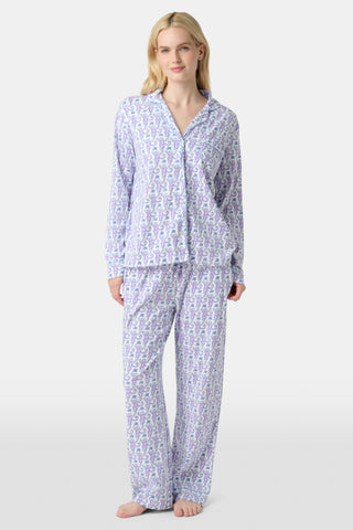 A close-up of Monkey Polo Pajamas made from pima cotton, featuring playful blue and pink monkeys holding branches on a white background—a cozy choice for a polo-style pajama set.