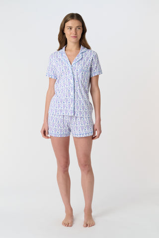 A close-up of Monkey Polo Pajamas made from pima cotton, featuring playful blue and pink monkeys holding branches on a white background—a cozy choice for a polo-style pajama set.