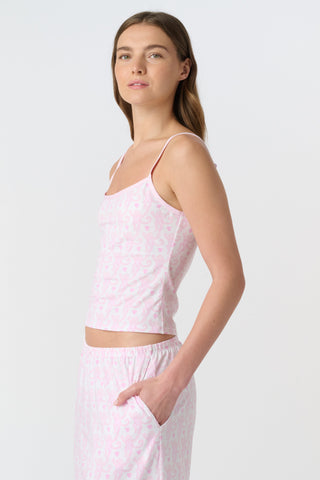 Woman with long brown hair wears a Roller Rabbit Lovely Monkey Clarkson Cami with adjustable straps and matching pajama pants, hands in pockets, standing against a plain light background.
