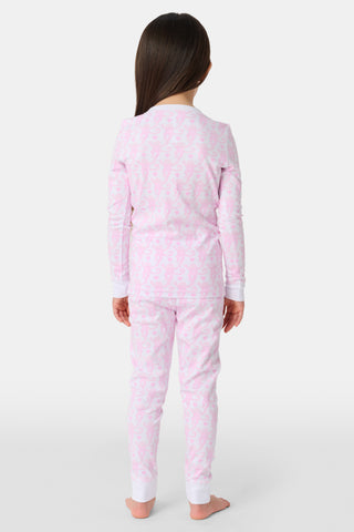 A child stands barefoot, smiling in Kids Lovely Monkey Pajamas with a playful monkey print and a buttoned neckline, set against a plain white background.