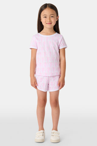 The Lovely Monkey Polo Pajamas feature a seamless pattern of pink cartoon monkeys and hearts on white, blending playful charm with the comfort of a women's short sleeve PJ set.