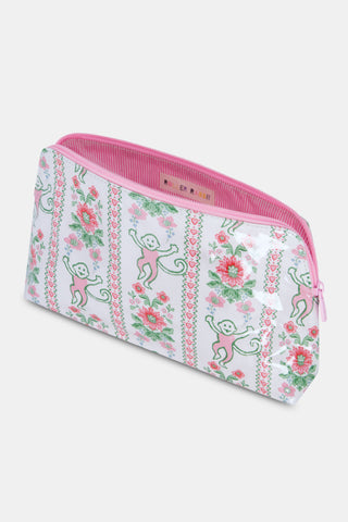 The Roller Rabbit Monkey Block Stripe Makeup Bag is a white zippered pouch with pink trim, decorated with playful pink and green flowers, hearts, and monkeys for a whimsical touch.