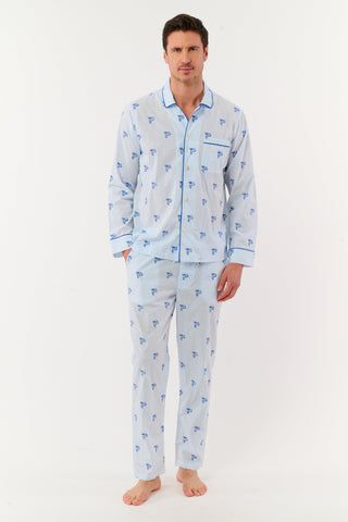 Man wearing a light blue pajama set with monkey patterns on a white background