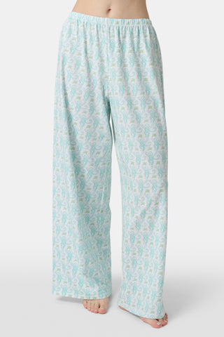 Wearing Roller Rabbit’s Monkey Monroe Pant in light blue and white heart-print cotton modal, the barefoot person stands against a white background, with only their lower torso and legs visible.