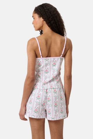 A woman with long curly hair wears the Roller Rabbit Monkey Block Stripe Mischa Set: a two-piece loungewear set featuring a matching camisole and shorts. She stands against a plain light background.