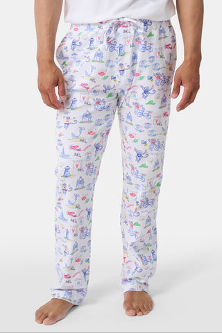 Crafted from soft Pima cotton, the Roller Rabbit Monkey On The Vineyard Long Sleeve Polo Pajamas feature a button-up long-sleeve top and long pants adorned with the playful Monkey on the Vineyard print, showcasing various animals, objects, and buildings on a plain white background.