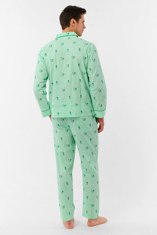 A man stands barefoot against a white background, smiling and facing forward, wearing Roller Rabbit's Mens Leo Gingham Loungewear—a light green, long-sleeved button-up set with matching pants featuring a small lion print pattern.