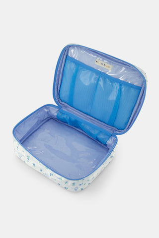 The Roller Rabbit Mini Monkey Blossom Carry All Case is a rectangular white fabric toiletry bag featuring a blue floral and monkey pattern, blue trim, a zip-around top closure, and a clear plastic handle on the lid.