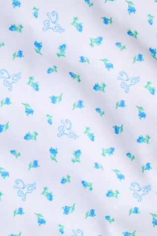 Introducing the Mini Monkey Blossom Bea Sweatpants from Roller Rabbit—white pajama pants featuring a blue and green Mini Monkey Blossom floral print, an elastic waistband, and "Sleep Club" text in blue on the left hip. These cozy sweatpants offer a relaxed, comfortable fit.