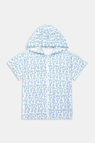 A young child smiles at the camera while wearing the Roller Rabbit Kids Monkey Jesse Cover Up, a light blue and white terry zip-up onesie with a playful animal pattern, against a plain background.