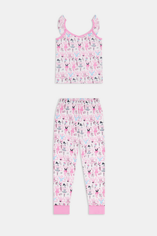 The Kids Monkey Pirouette Blaire Pajamas by Roller Rabbit is a children's pajama set crafted from soft Pima cotton, featuring a sleeveless top with ruffled straps and long pants, both in white with a playful pink, blue, and black monkey cartoon print and pink trim.