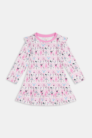 The Roller Rabbit Kids Monkey Pirouette Isa Dress features long sleeves, a pink collar, and ruffle shoulders. Crafted from soft Pima Cotton for all-day comfort, this dress showcases a playful pattern of cartoon monkeys dancing pirouettes on a white background.