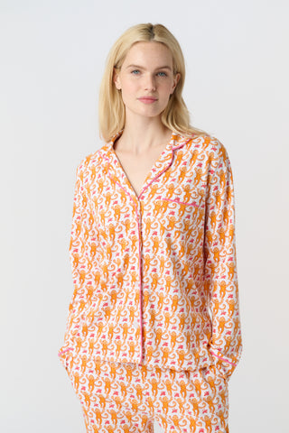 Playful orange monkeys and pink butterflies pop on a white background. The Monkey Polo Pajamas bring whimsy and color to your pima cotton collection, making this matching set a standout favorite for fun, lively sleepwear.