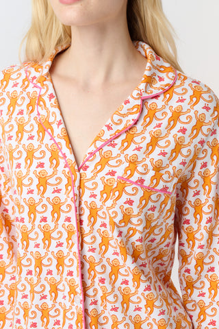 Playful orange monkeys and pink butterflies pop on a white background. The Monkey Polo Pajamas bring whimsy and color to your pima cotton collection, making this matching set a standout favorite for fun, lively sleepwear.